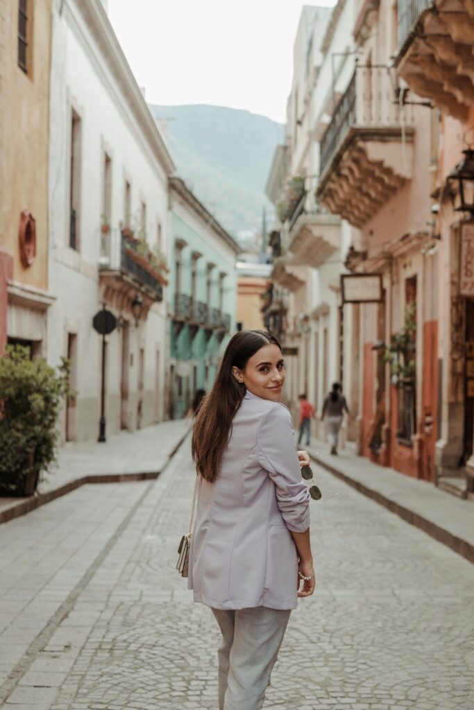 pexels-photo-13305456-13305456 A fashionable woman walks down a historic cobblestone street in Guanajuato, Mexico.